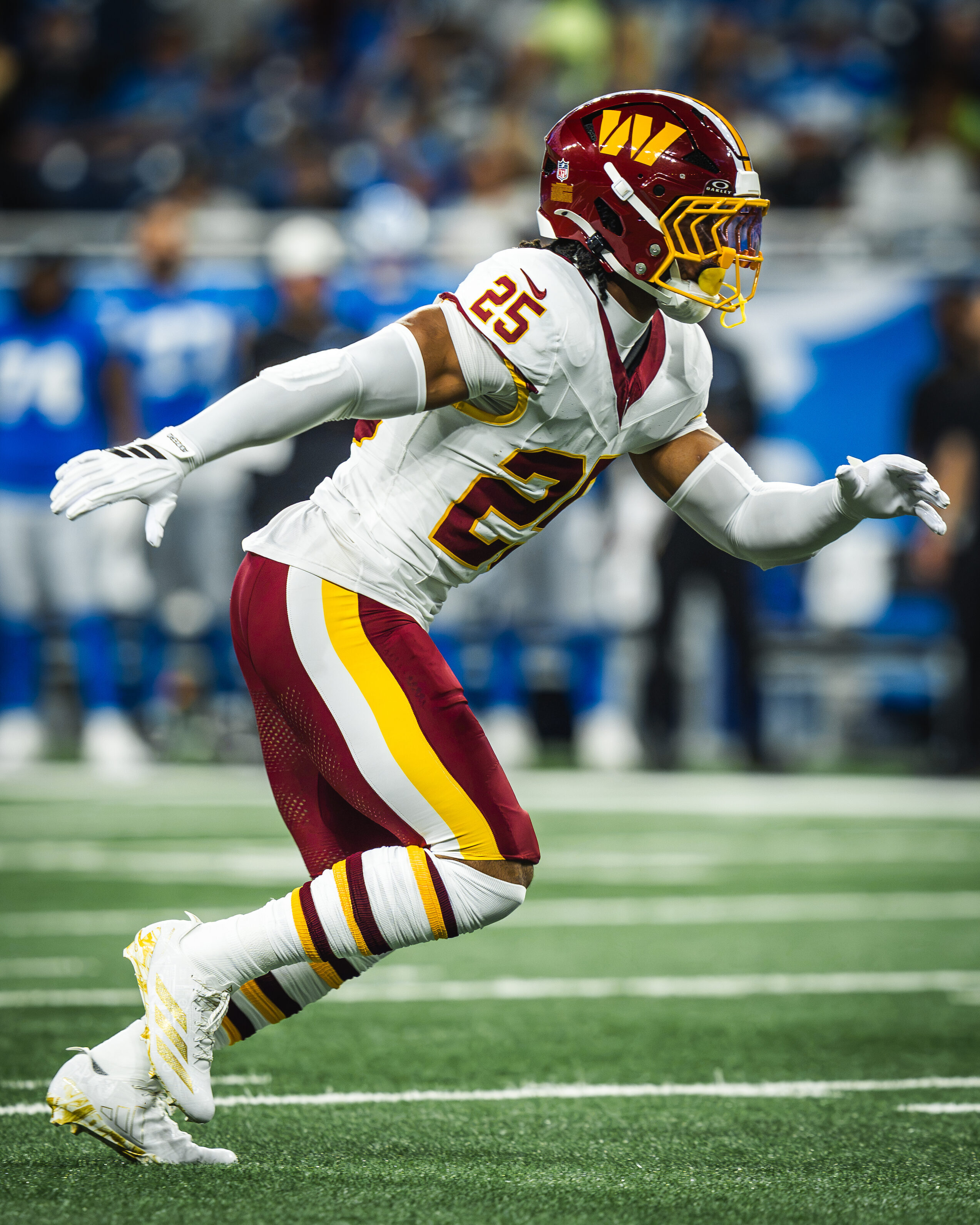Nick Cross, number 25, sprinting in coverage with his arms extended in his white Washington Commanders away uniform
